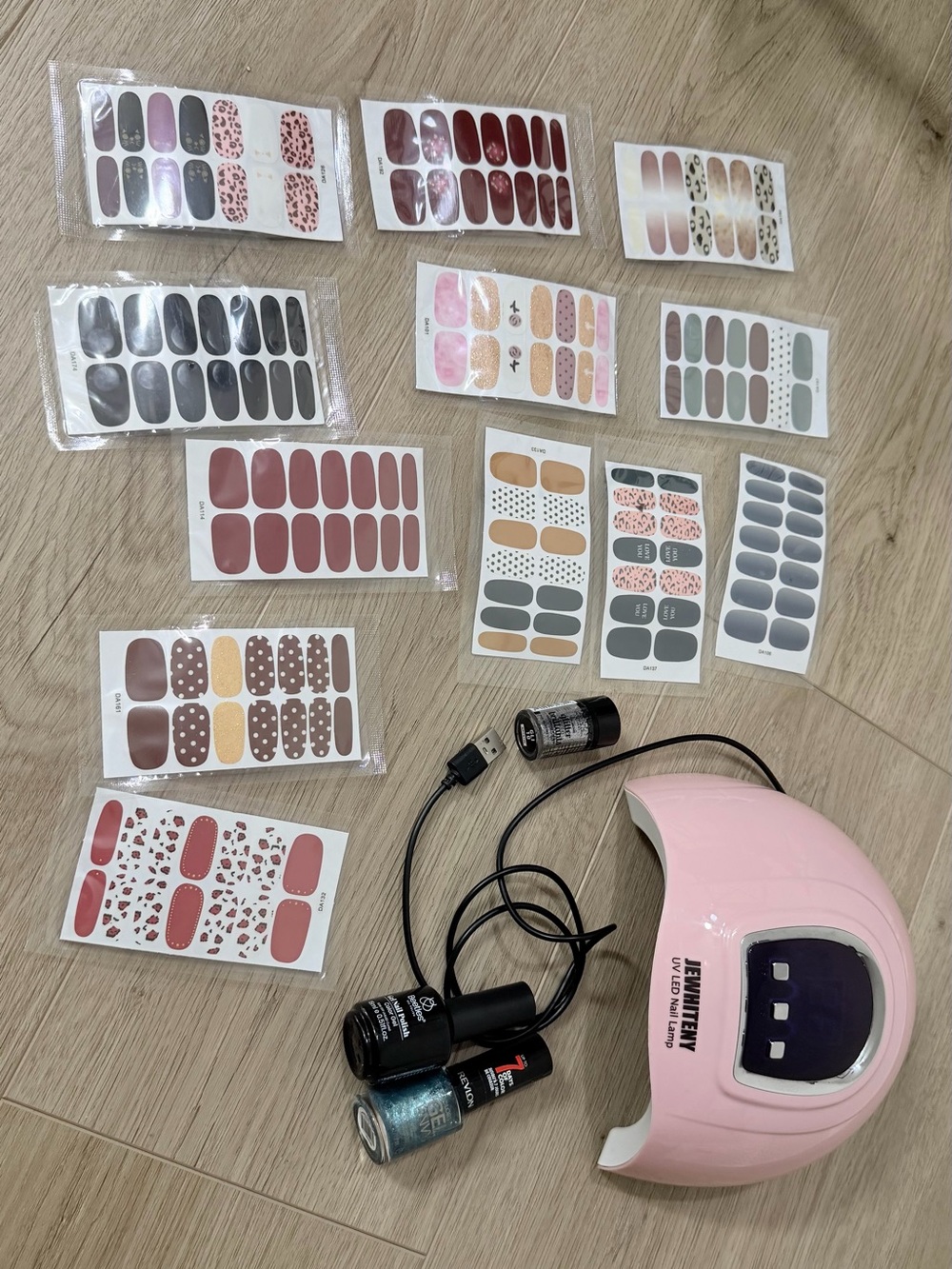 Pink LED UV Nail Lamp with Assorted Nail Wraps and Polishes